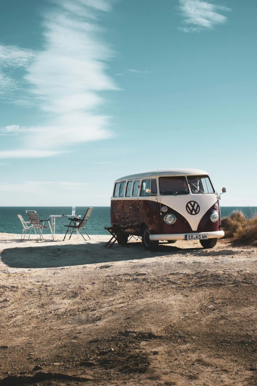 a van parked at the edge of the beach