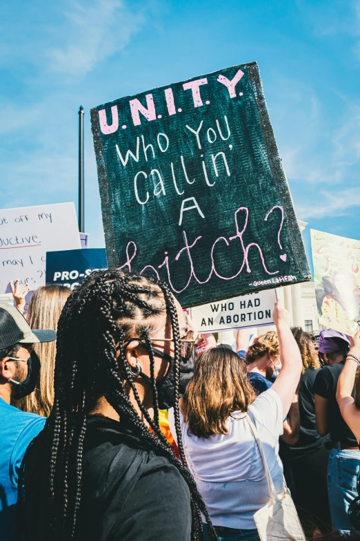 protestors hold up signs and take their place