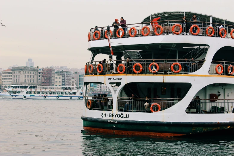 a double decker bus on water near boats