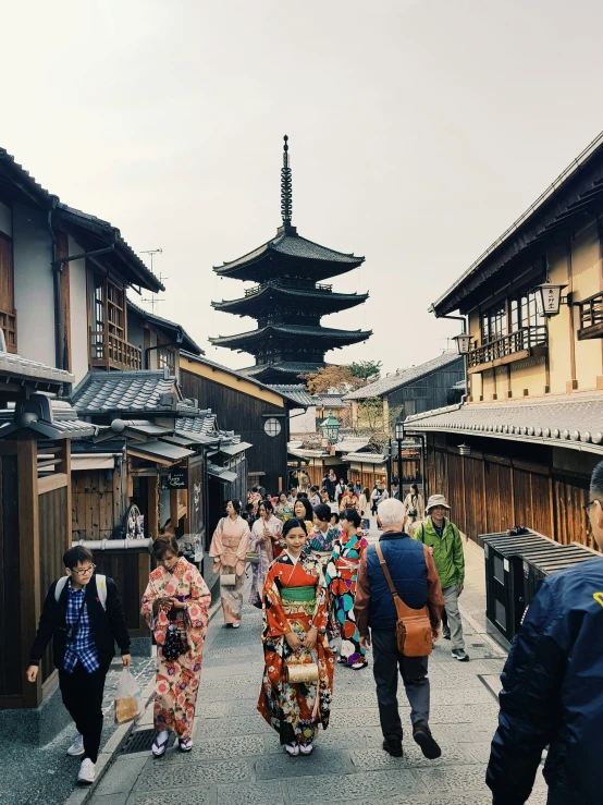 people in colorful dresses walking on paved street