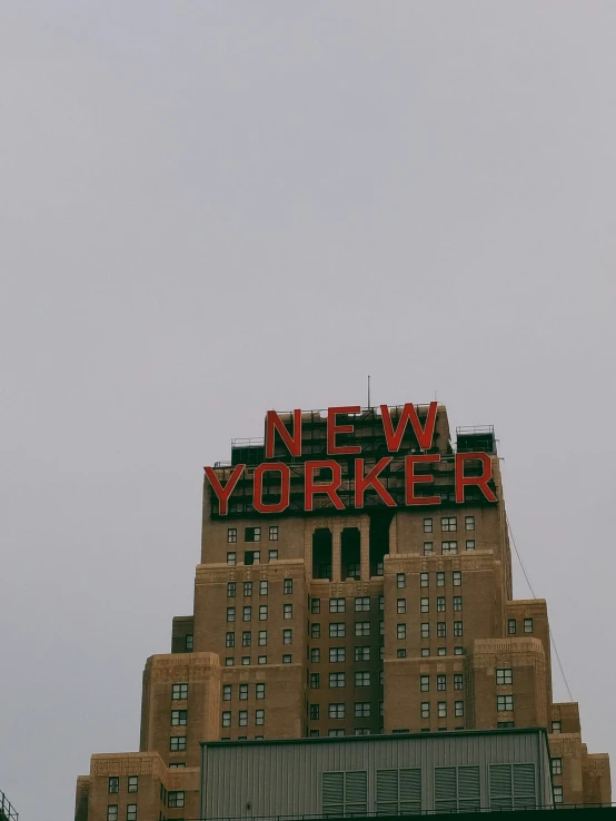 a large sign is mounted on the top of an old building