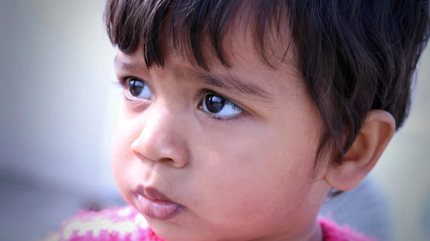 a close up view of a child with blue eyes