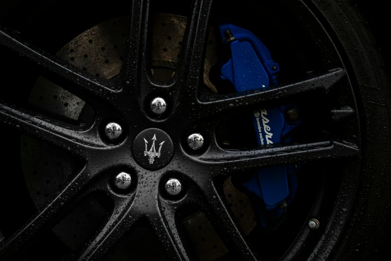 this wheel is painted blue with a white emblem