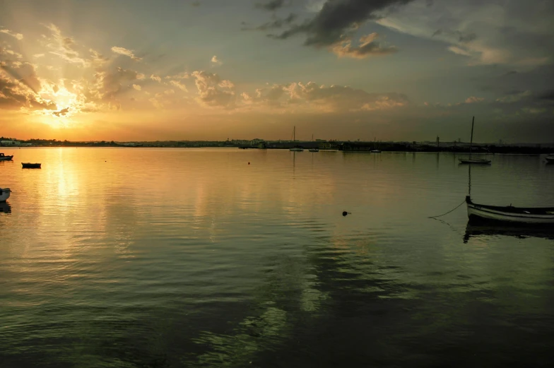 a harbor is lit by the sun setting