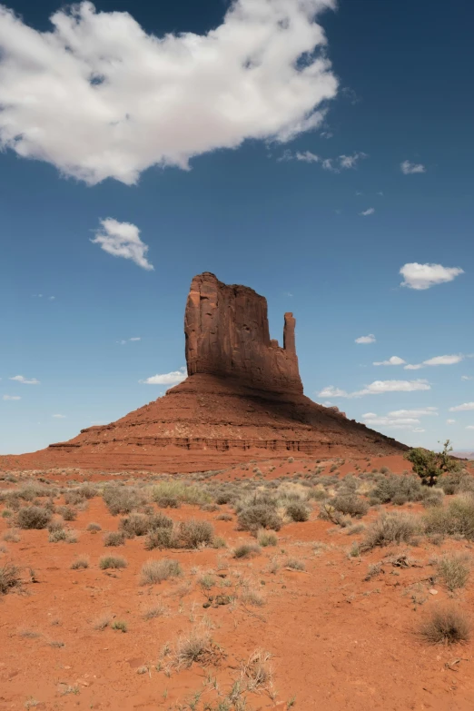 a tall rock formation in the middle of a desert