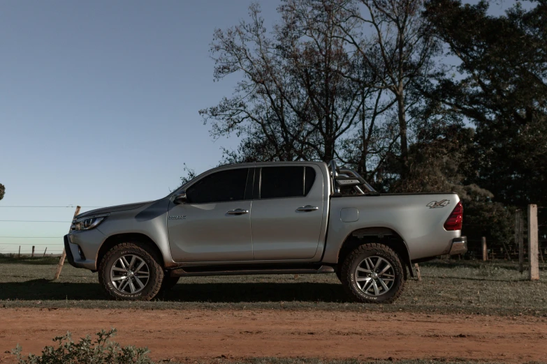 a truck is parked in a dusty field