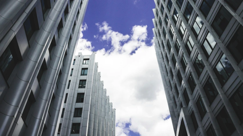 the view looking up at some buildings from the ground