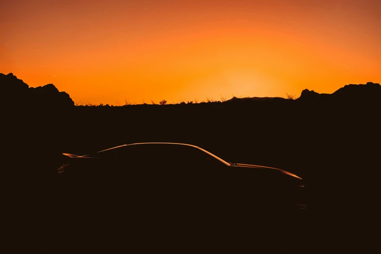 a car driving in front of the sun