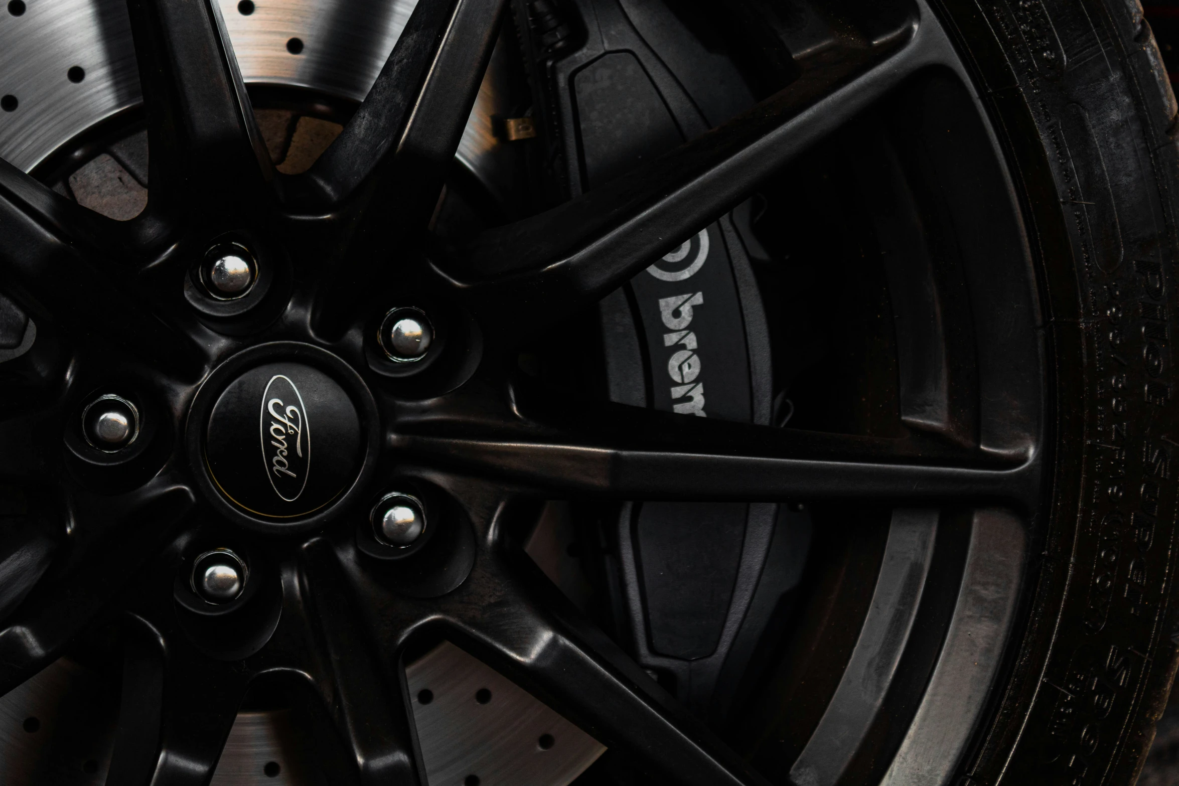 the rim of a sports car with black wheels