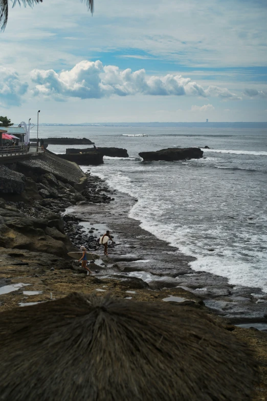 a beach with lots of water and large rocks