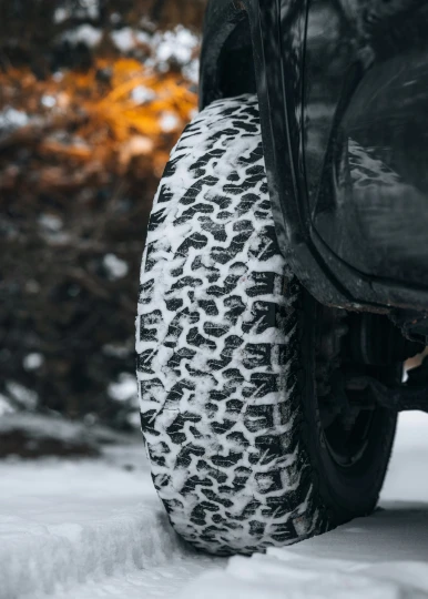 a close up view of tire treads with snow on the ground