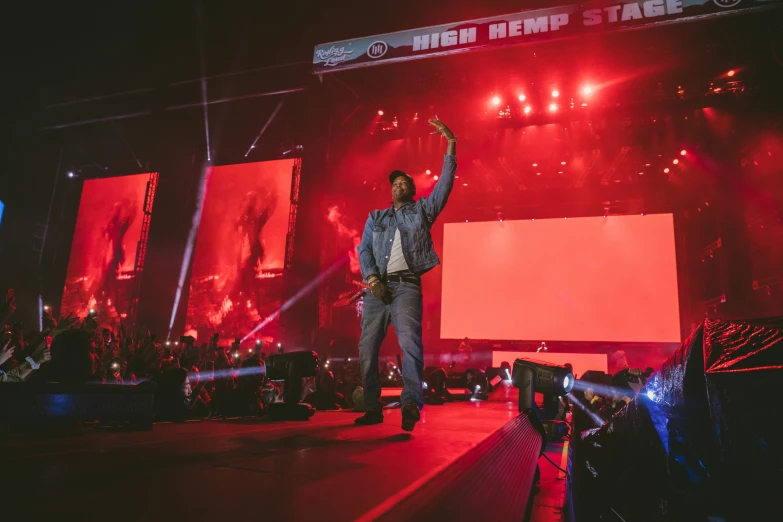 a man standing on a stage and waving