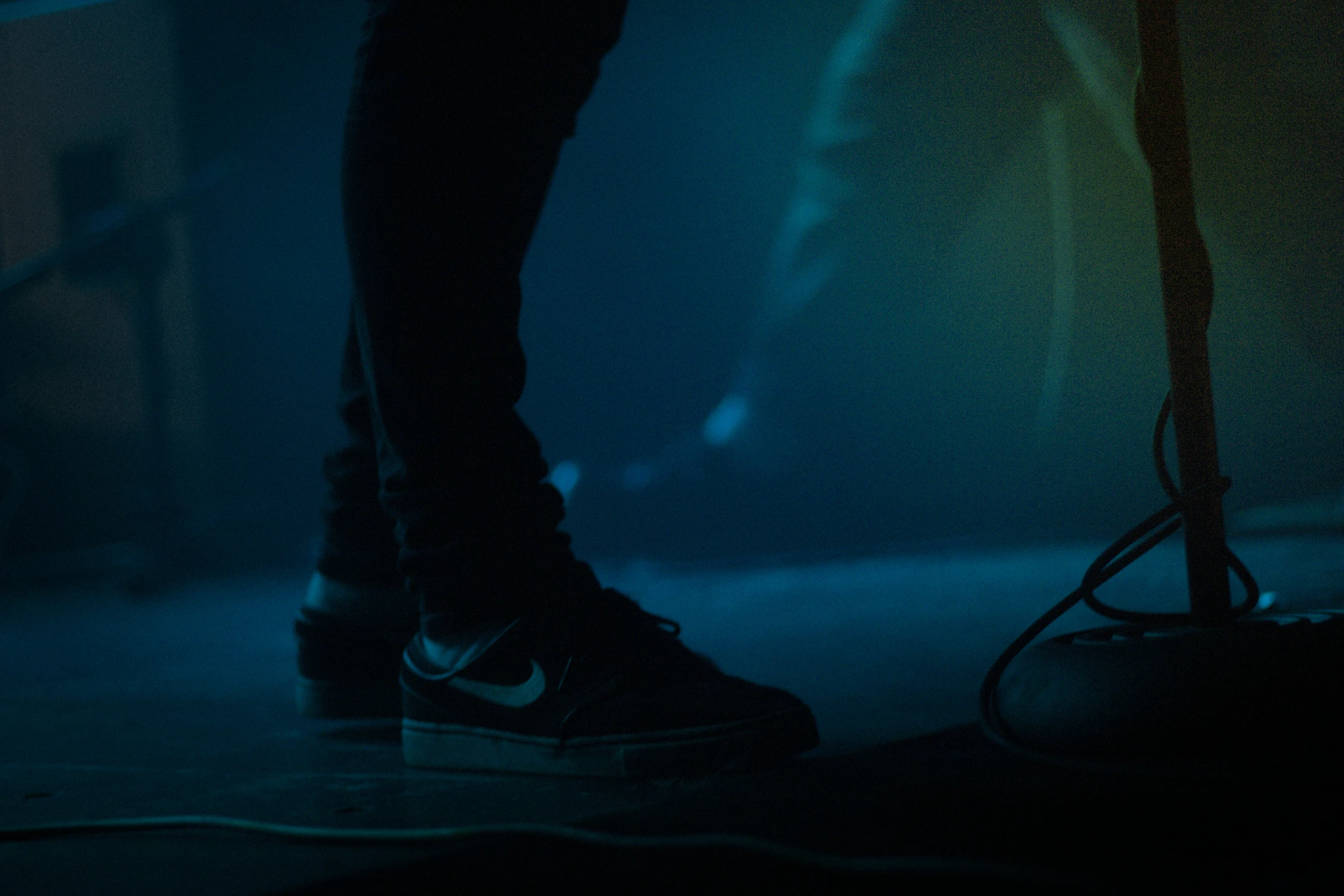 the shoes on a skateboard in front of a dark background