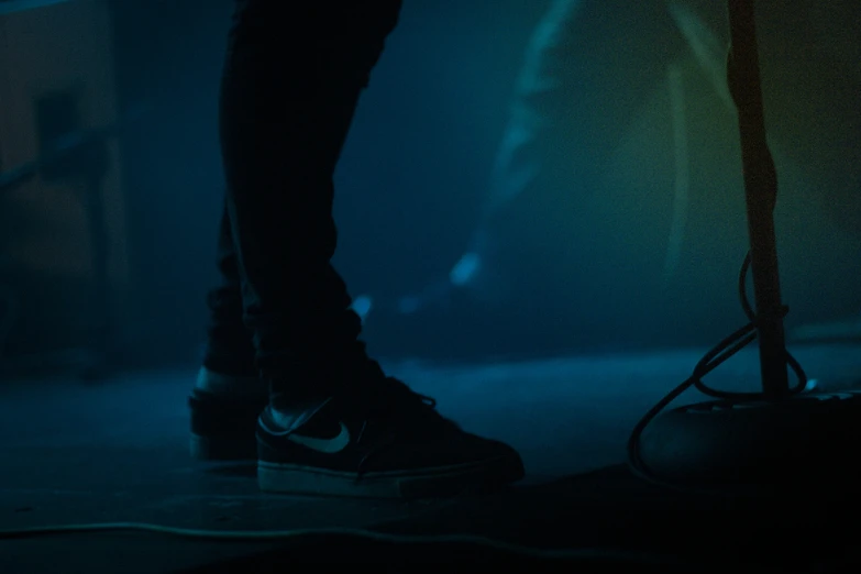 the shoes on a skateboard in front of a dark background