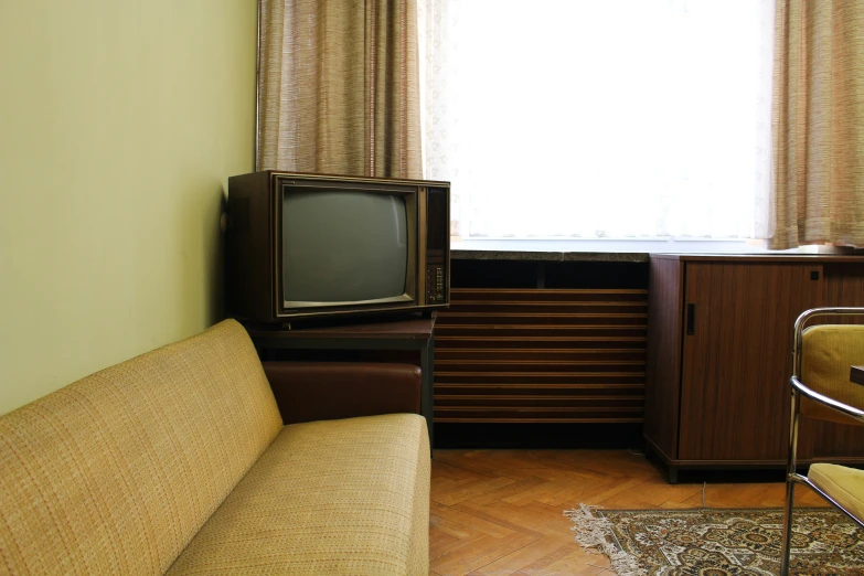 there is a small tv and cabinet in the room