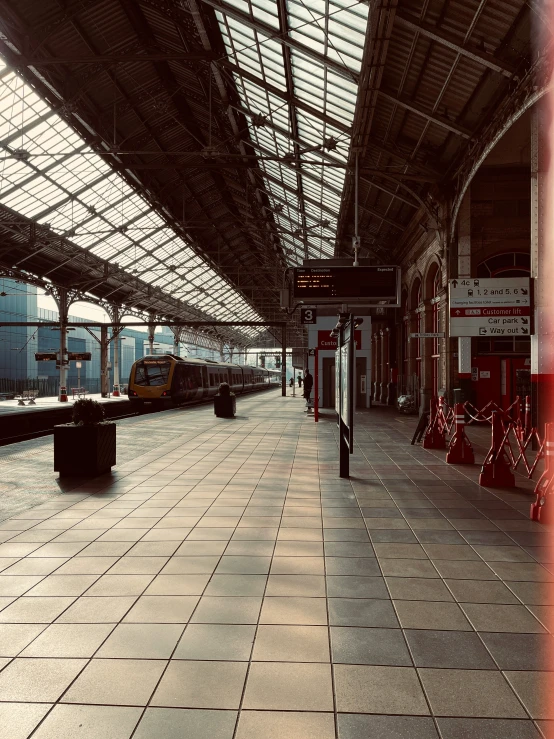 an empty train station with a large long red flag