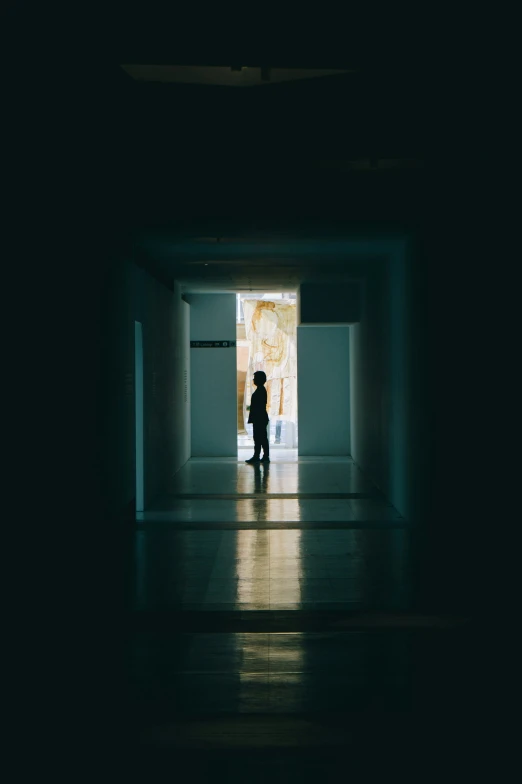 a person walking into an empty room that has a door