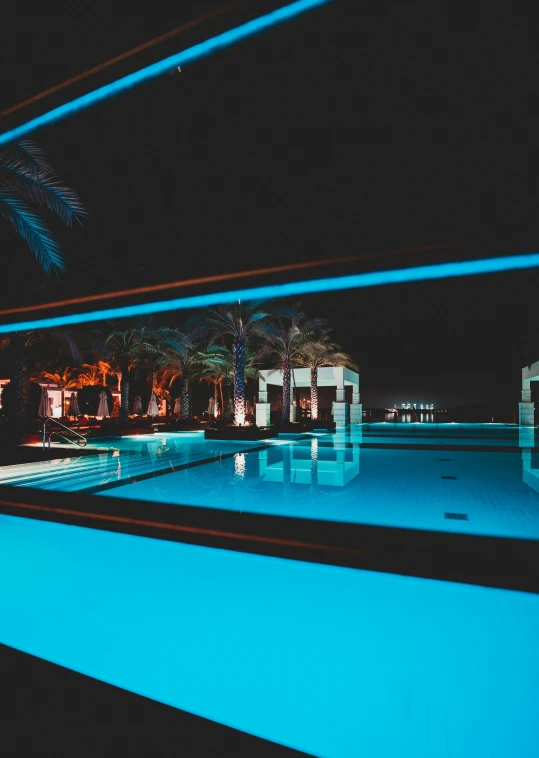 an empty swimming pool with blue lights on it
