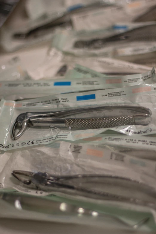 several pieces of surgical equipment are laying on a pile of paper