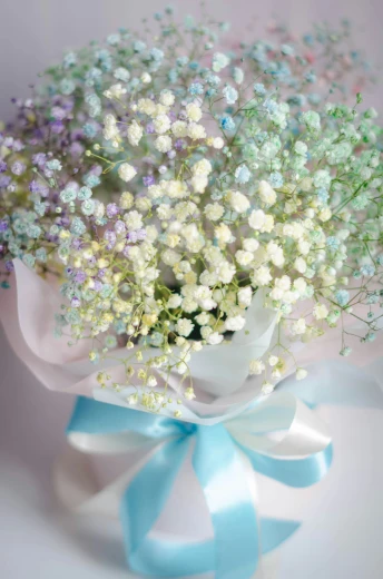 a bunch of white and blue flowers is in a vase