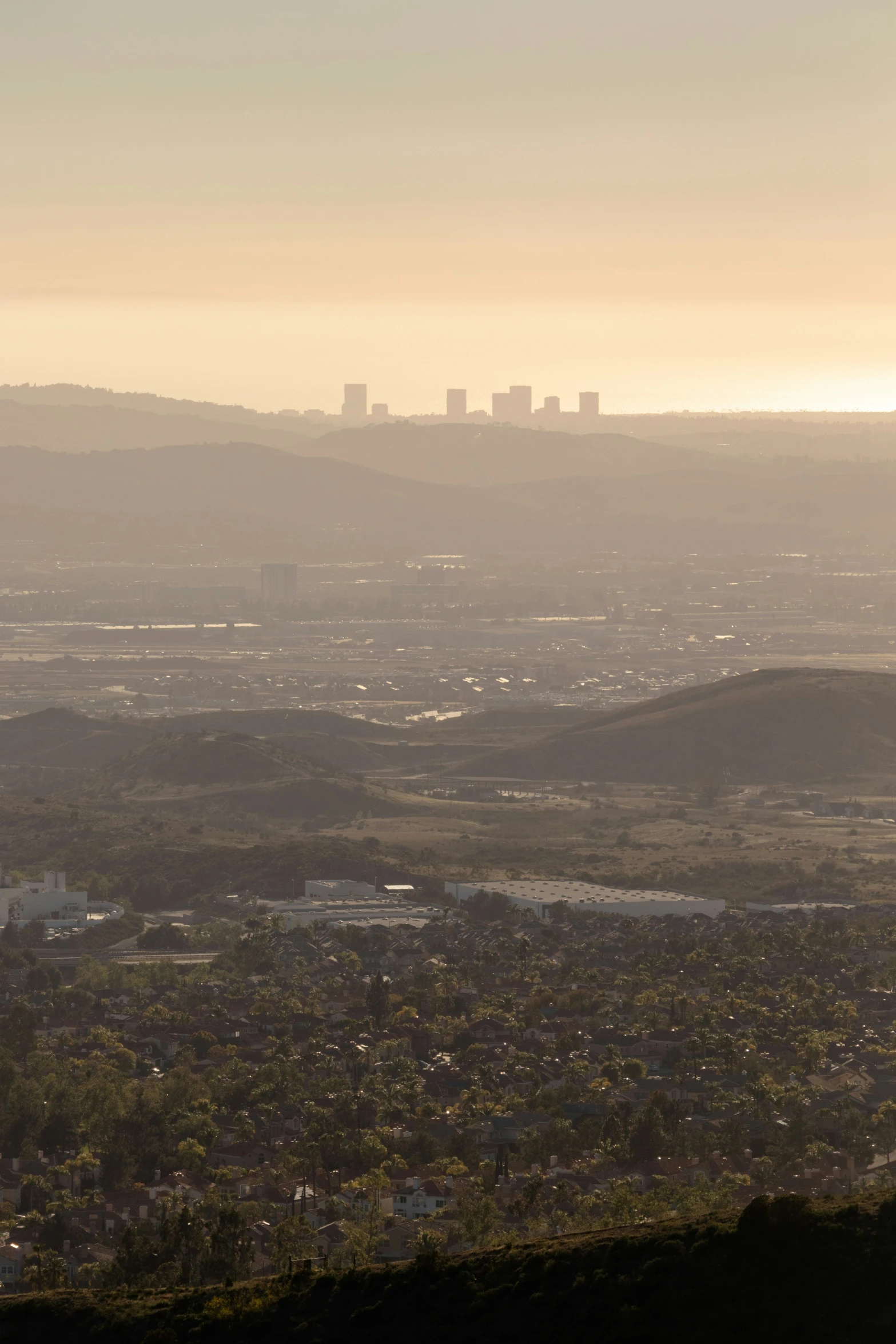 a city view from a high hill with mountains in the distance