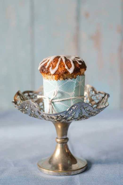 a cup cake is on a silver plate