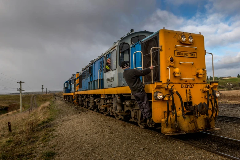 the yellow train car has a face drawn on the front