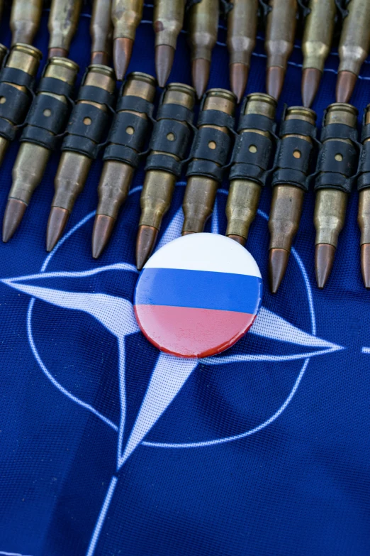 an emblem on a blue piece of cloth near some small bullet shells