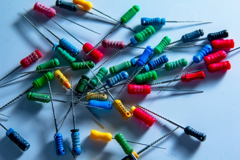 a pile of h pins next to each other on a table