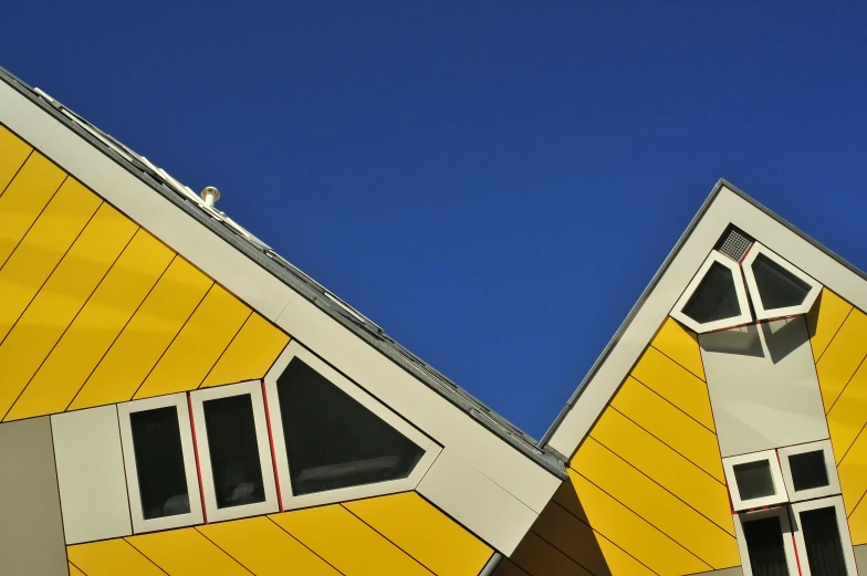 two modern wooden homes on a blue sky day