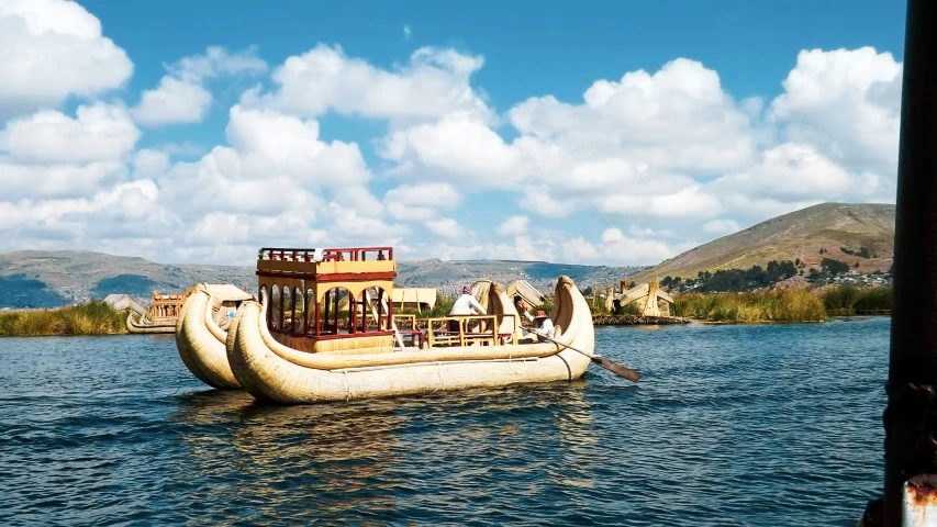 a long boat on the water with two people in it