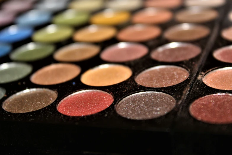 a collection of colorful makeup in shallow focus