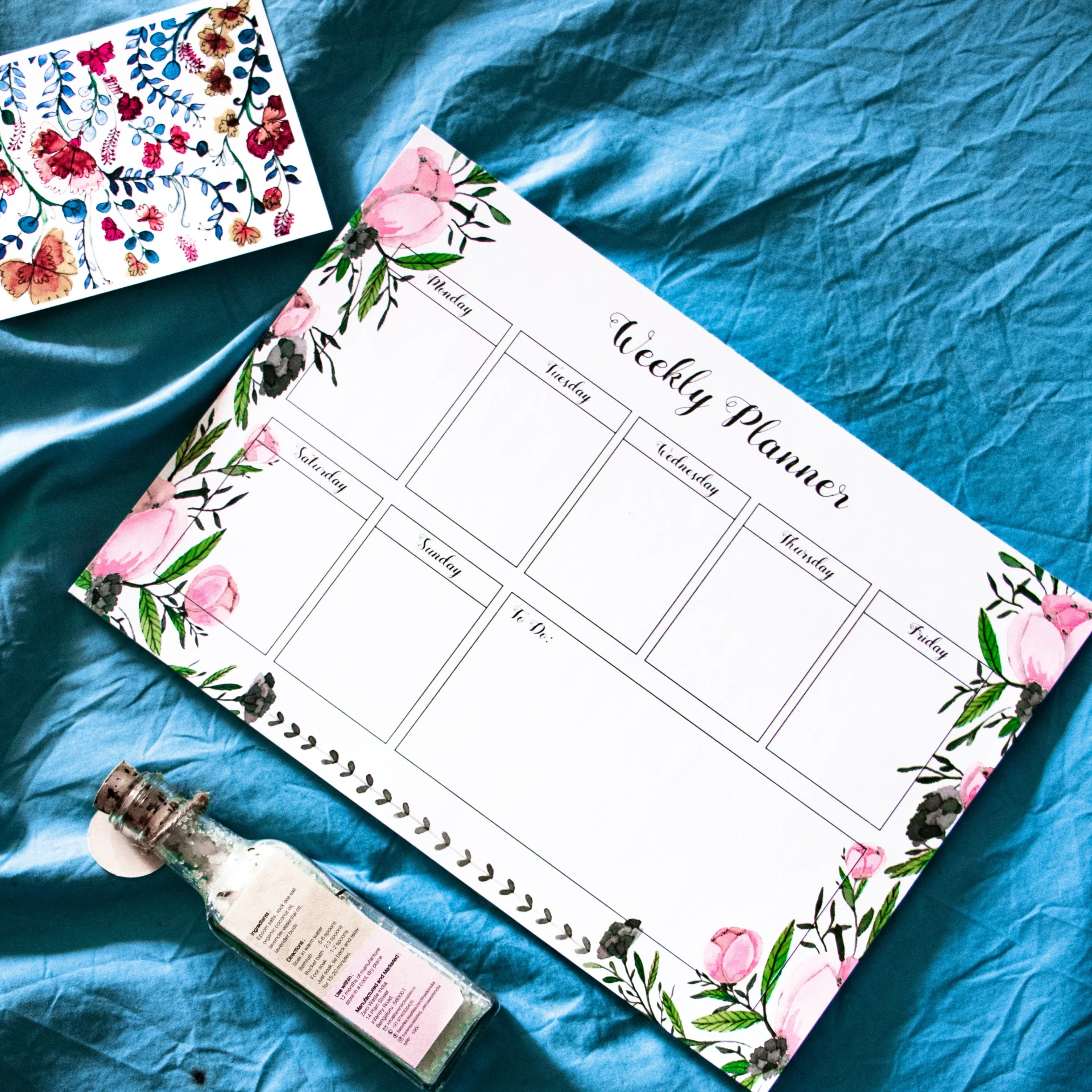 a personal check list with pink flowers, seeds and an empty bottle