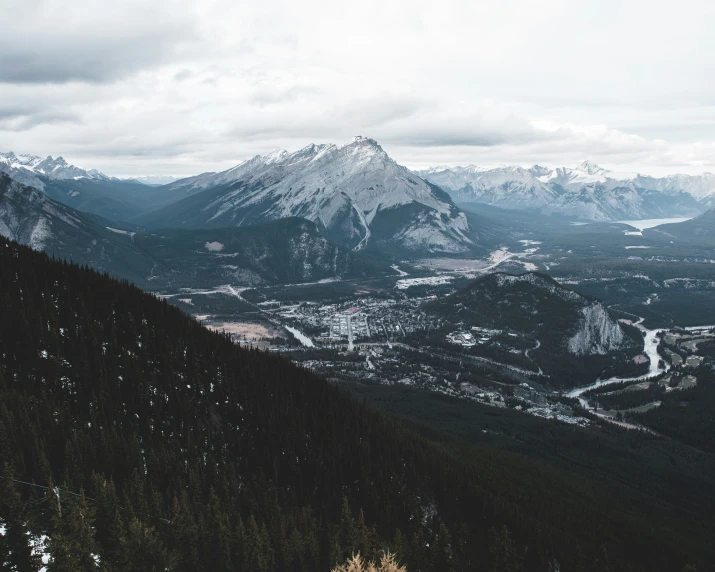 the view from atop of mountains of snowy valley and forest