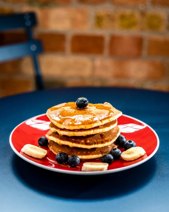 there are pancakes and blueberries on the plate