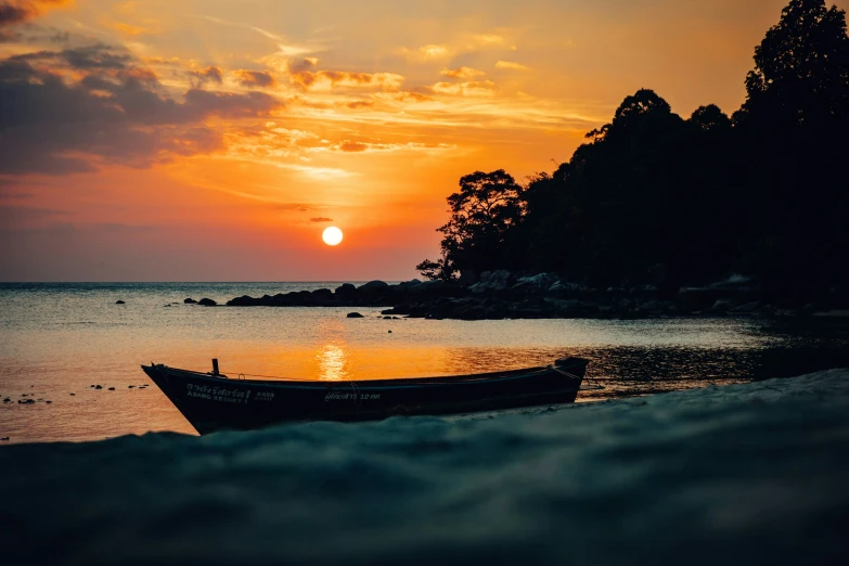 a boat sitting in the middle of the ocean