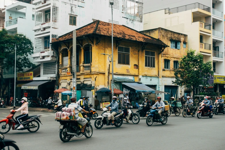 a street filled with people riding motorcycles down a busy city street