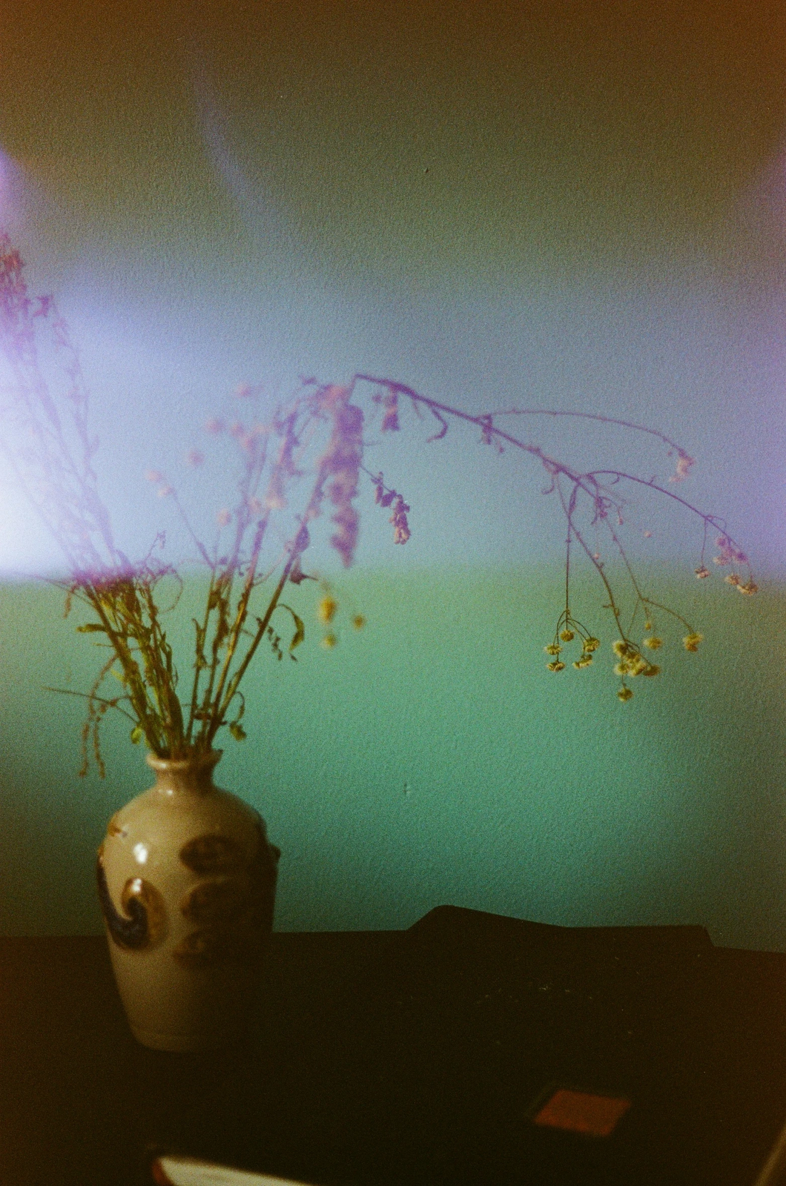 a vase filled with flowers sitting on top of a table