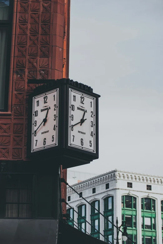 a clock that is attached to the side of a building