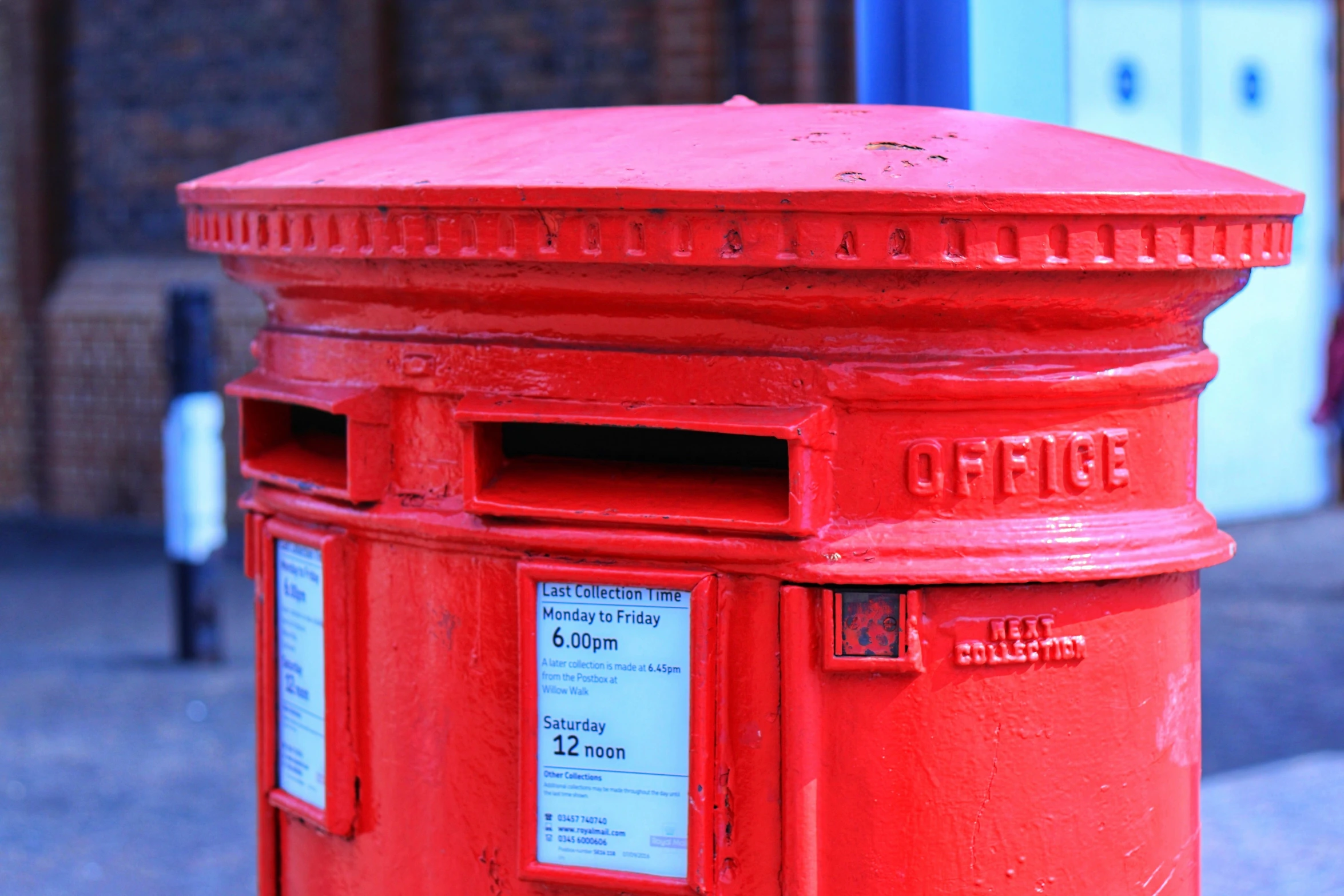 a red mailbox on the side of a road