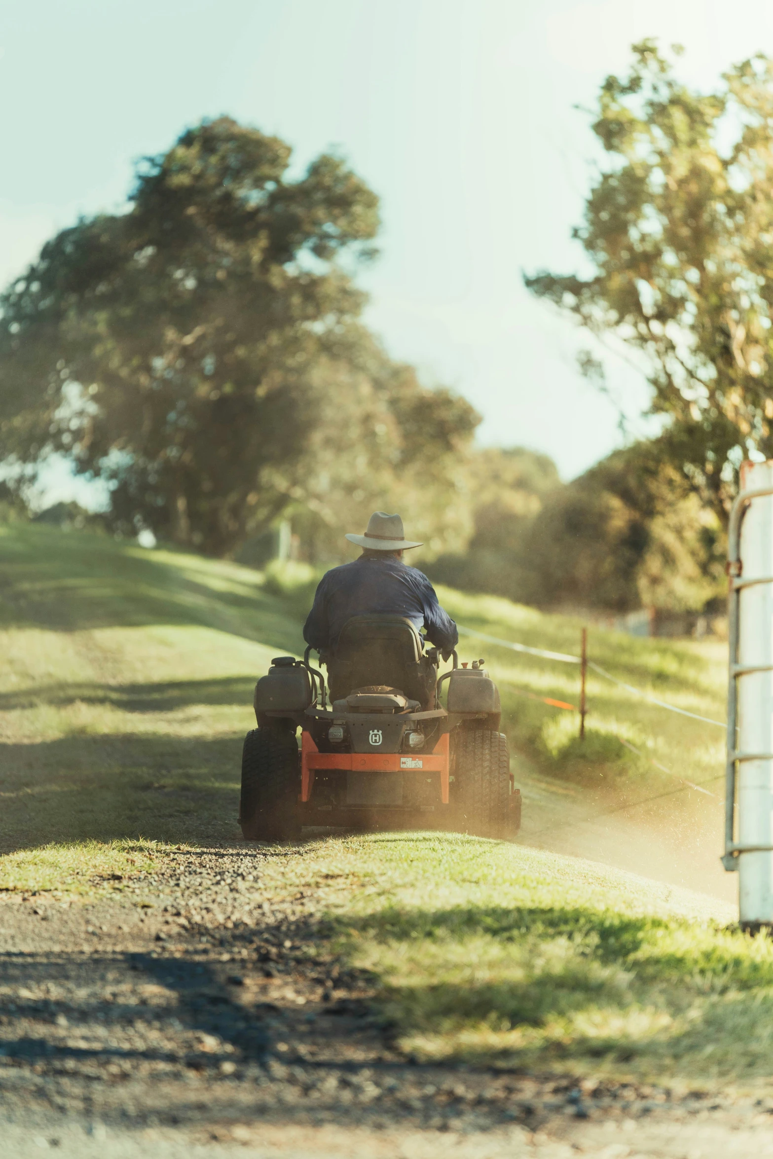 the old man is riding on the lawn mower