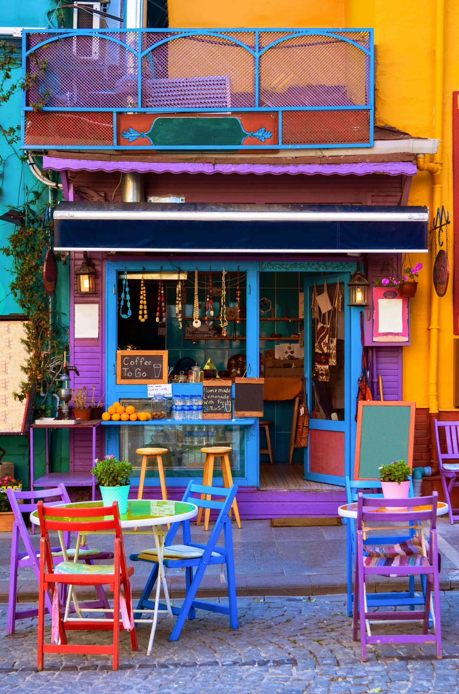 a storefront is displayed outside in multicolored chairs