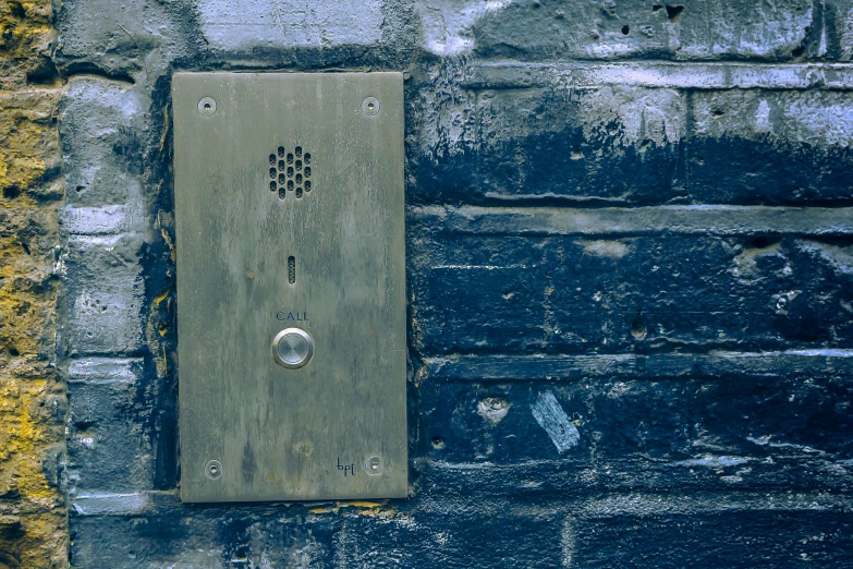 a brick wall with a decorative tile phone