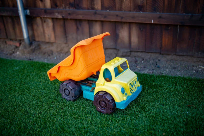 toy truck with cloth over it's side sitting on the grass