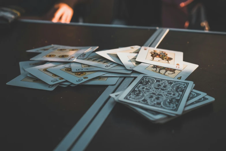 several cards with an artistic pattern lay atop a black table