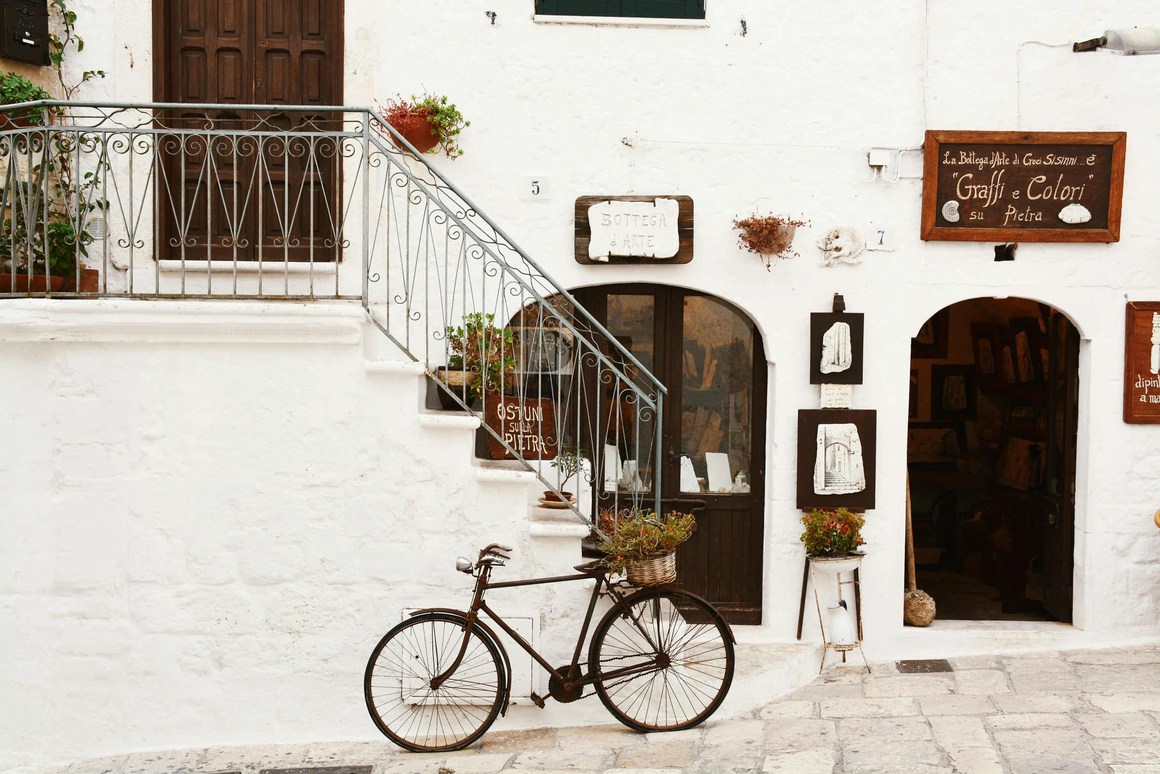 a bicycle parked outside of a house on the side of the street