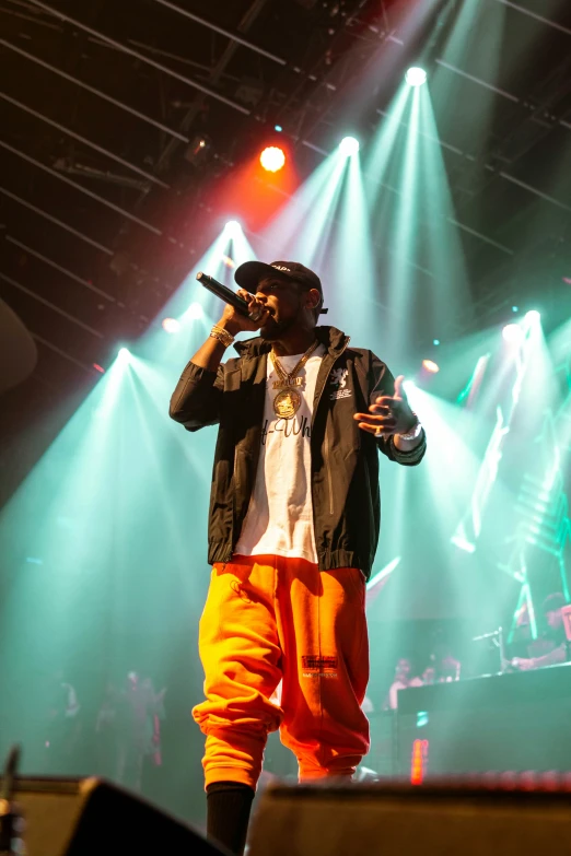 a man that is standing on stage with a microphone