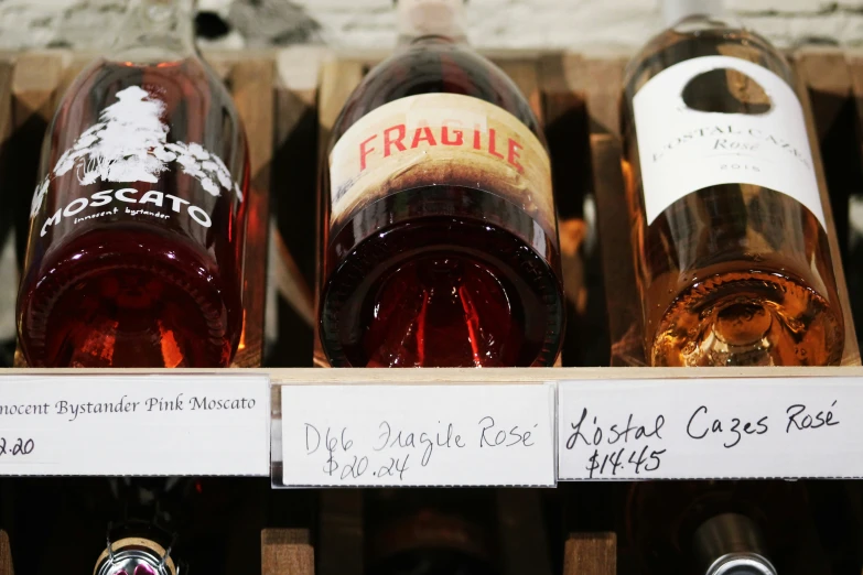 many different types of wine sit in a crate