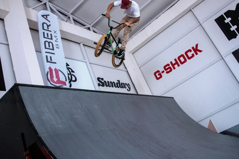 a man that is jumping his bike on a ramp