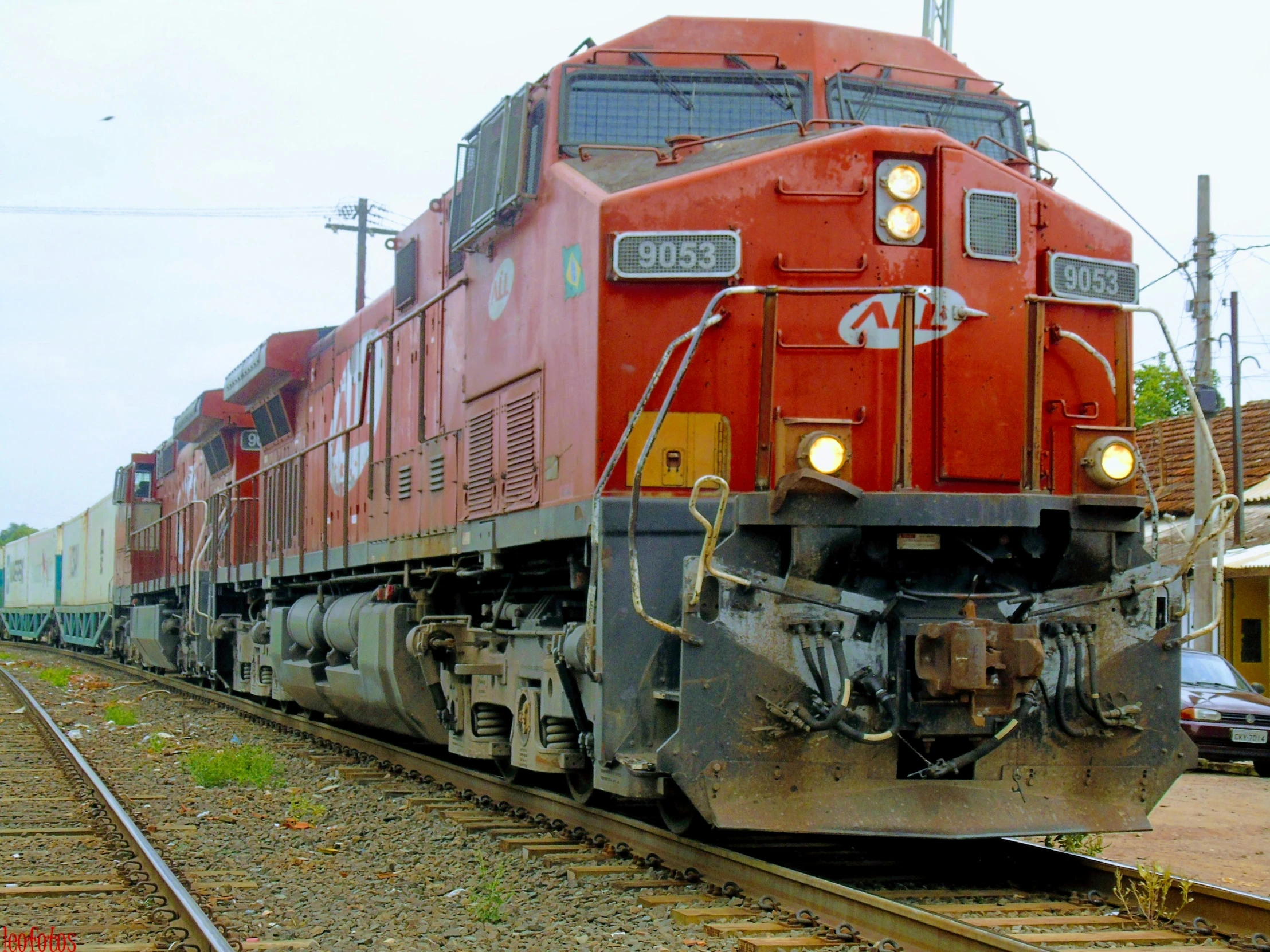 a big red train traveling down train tracks